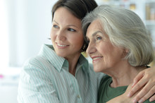 Close Up Portrait Of Senior Woman With Daughter At Home