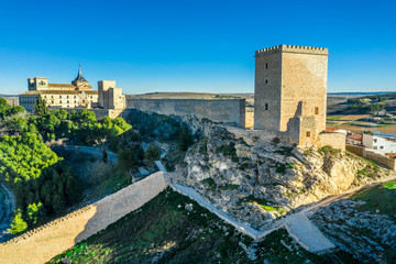 Aerial sunny afternoon view of Ucles castle and monastery historic medieval walled town in Cuenca province Spain