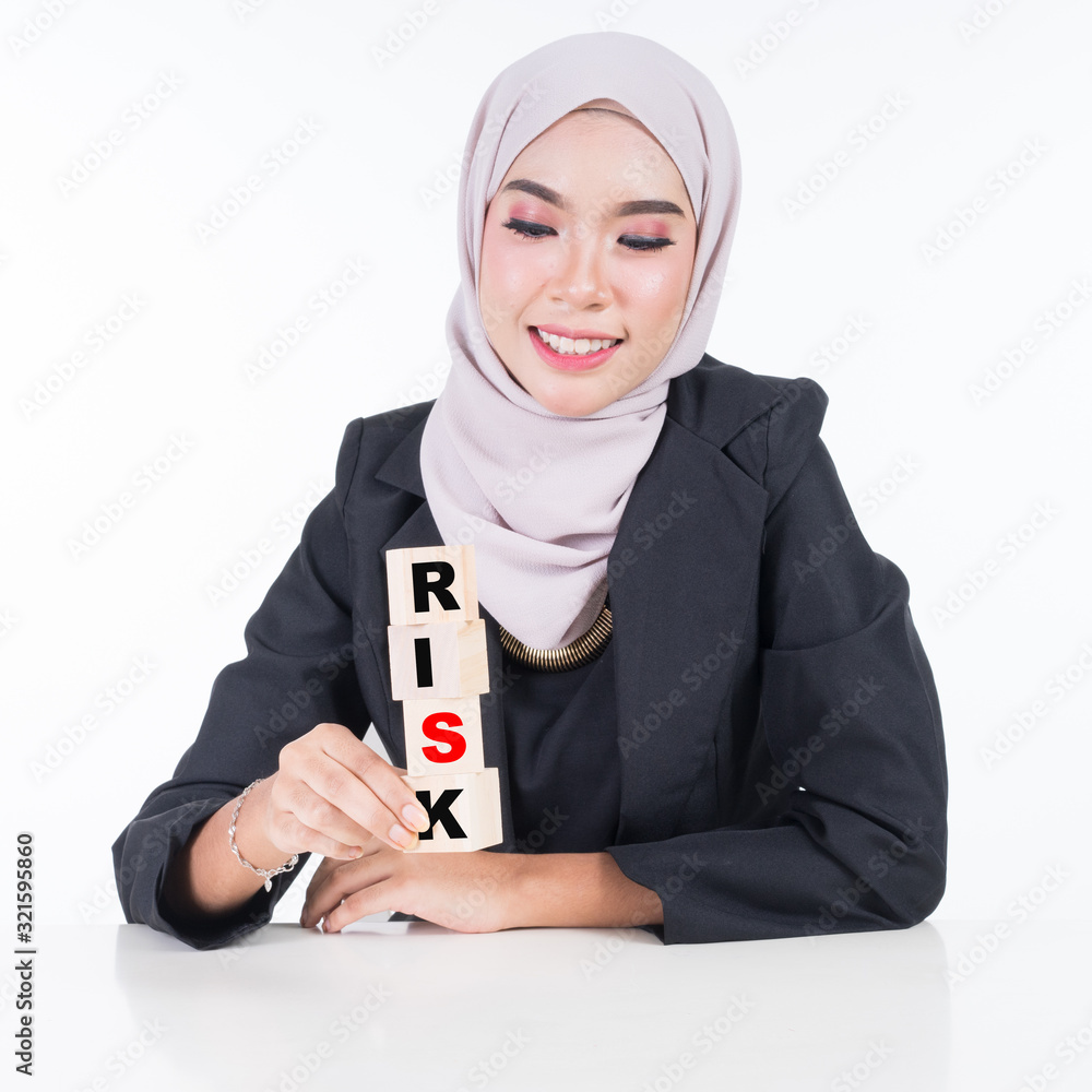 Asian Muslim woman in business attire and hijab. handling blocks with ...