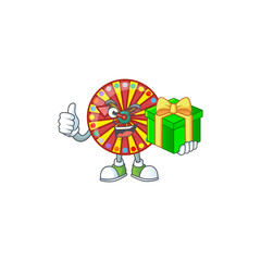 Wall Mural - Cute wheel fortune character holding a gift box