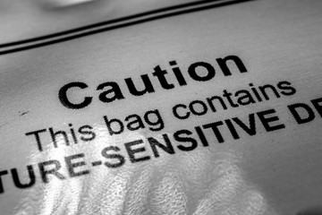 Close-up of vacuum barrier bag caution warning of moisture sensitive devices label from electronics assembly industry