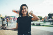 Half length portrait of cheerful excited asian woman resting on vacation in park with fairs and entertainment, positive smiling teenager hipster girl having fun with soap bubbles on city festival.