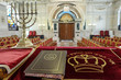 Holy book and menorah on altar in Moroccan synagogue.