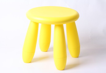 Small yellow plastic stool for kids isolated on white