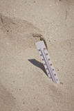 Fototapeta  - Thermometer on sand, summer scene 