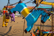 Carousel With Wooden Horses In Beach For Kids Fun. Merry Go Round As Part Of Fun Activities In Marina Beach, Chennai, India.