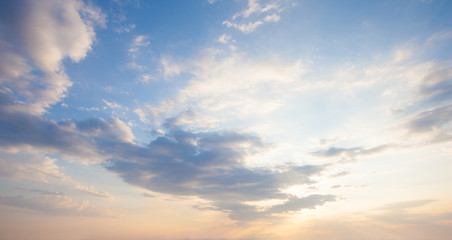 Blue sky clouds background. Beautiful landscape with clouds and orange sun on sky