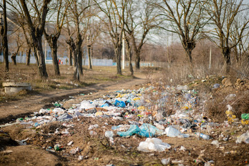 A pile of trash abandoned on the grass, littering and polluting the environment