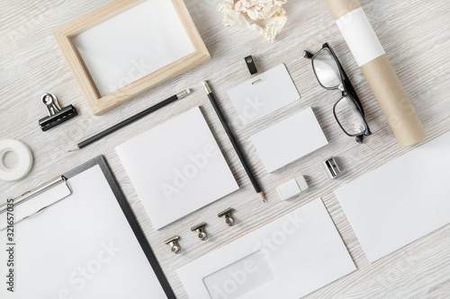 Cuadros en Lienzo Photo of blank stationery set on light wooden background