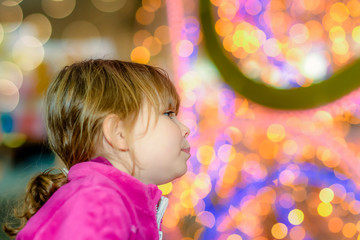 Wall Mural - cute little girl in front of christmas decorations