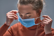 Leinwandbild Motiv Healthy woman putting on medical protective mask to health protection and prevention during flu virus outbreak, epidemic and infectious diseases