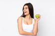 © luismolinero - Young woman over isolated white background with an apple and happy