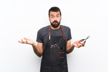 Barber man in an apron having doubts while raising hands