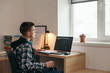 © Alena Ozerova - Teenage boy doing homework using computer sitting by desk in room alone