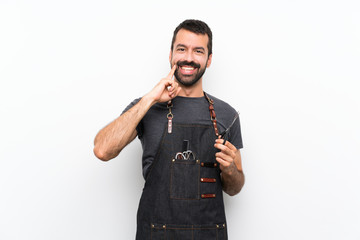 Wall Mural - Barber man in an apron smiling with a happy and pleasant expression