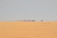 A Mirage Is A Naturally Occurring Optical Phenomenon In Which Light Rays Bend To Produce A Displaced Image Of Distant Objects Or The Sky. Mirage At Arabian Desert.