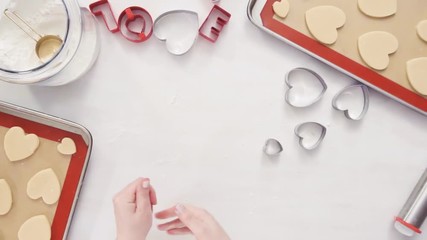 Poster - Flat lay. Step by step. Cutting out shapes from sugar cookie dough with cookie cutters.