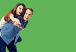 © vgstudio - Love, relationship, dating, lovers, romantic concept - happy excited couple, in piggyback pose, over green background. Copy space for some text.