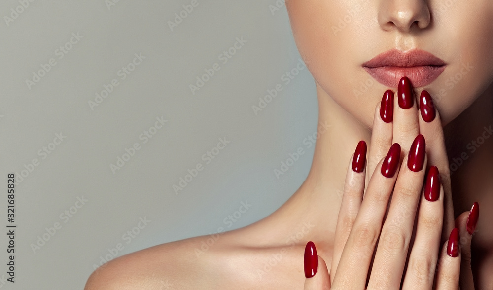 Beautiful girl   . Model woman showing  red  shellac manicure on nails   . Cosmetics ,beauty and makeup - obrazy, fototapety, plakaty 