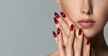 Beautiful Girl   . Model Woman Showing  Red  Shellac Manicure On Nails   . Cosmetics ,beauty And Makeup
