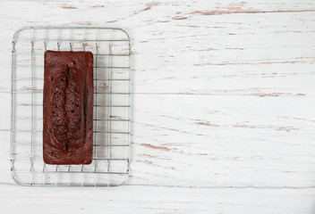 Wall Mural - Homemade chocolate pound cake loaf. Delicious dessert for Breakfast. A treat for tea on a light wooden table. Selective focus, copy space