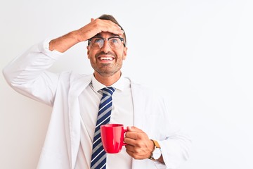 Canvas Print - Young handsome therapist man drinking coffee over isolated background stressed with hand on head, shocked with shame and surprise face, angry and frustrated. Fear and upset for mistake.