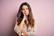 © Krakenimages.com - Young beautiful brunette woman wearing casual sweater standing over pink background thinking looking tired and bored with depression problems with crossed arms.