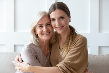 headshot portrait of mature mom and adult daughter posing