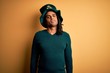 © Krakenimages.com - Young african american man wearing green hat with clover celebrating saint patricks day Relaxed with serious expression on face. Simple and natural looking at the camera.