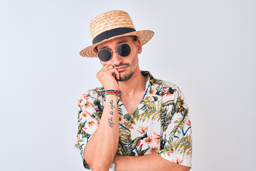 Wall Mural - Young handsome man wearing Hawaiian shirt and summer hat over isolated background thinking looking tired and bored with depression problems with crossed arms.