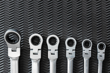 Car repair tools, wrench tool set on a black texture background