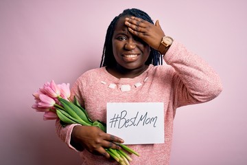 Poster - Plus size african american woman holding best mom message and tulips on mothers day stressed with hand on head, shocked with shame and surprise face, angry and frustrated. Fear and upset for mistake.