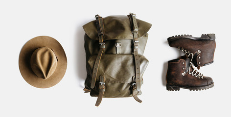 Wall Mural - minimalist style composition of hat, backpack and boots on white background isolated