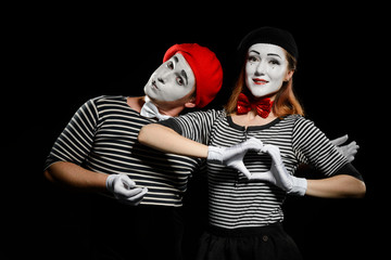 Wall Mural - Pretty couple of mimes on black background