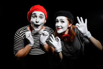 Wall Mural - Cute mime artists on black. Waist up portrait of man and woman