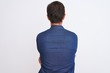 Middle age handsome man wearing blue denim shirt standing over isolated white background standing backwards looking away with crossed arms