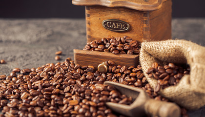 Wall Mural - Ground coffee and coffee beans on old cafe table.