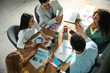 © New Africa - Team of professional designers working together at table in office