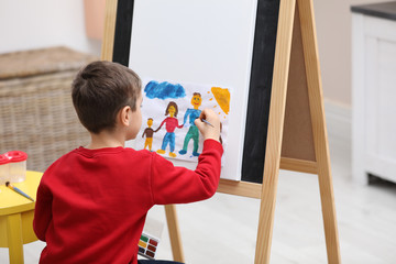 Poster - Little child painting on easel in room