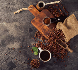 Poster - Ground coffee and coffee beans on old cafe table.