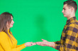 © Andrii - Couple dressed in yellow and black clothes, presenting something, holding hands opened together.