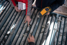 Team Of Mining  Workers Measuring Drilled Rock Core