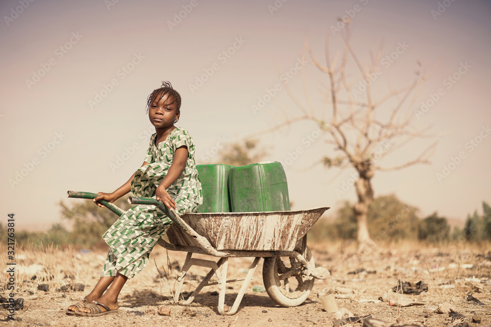 Real Indigenous Youngster Saving Healthy Water in a village - obrazy, fototapety, plakaty 