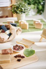 Ingredients And Homemade Soap Bars On Table In Natural Cosmetics Store