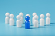 © Alexander - The leader in blue leads a group of white employees to victory, HR, Staff recruitment. The concept of leadership.