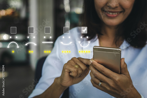 Cuadros en Lienzo Businesswoman pressing face emoticon on virtual touch screen at smartphone