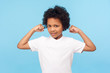 © khosrork - I'm strong. Portrait of adorable little boy in white T-shirt showing biceps, expressing power and self-confidence, feeling strength to protect himself. indoor studio shot isolated on blue background