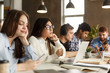 © Prostock-studio - Students in library. Concentrated girl making research project