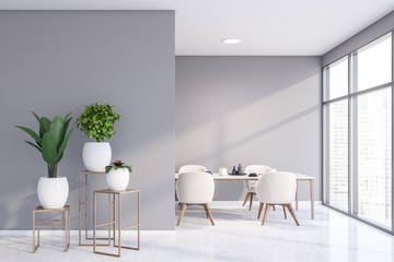 Light gray dining room with potted plants