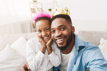 Joyful Afro Father And Daughter Wearing Crowns And Taking Selfie
